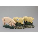 Three cast iron door stops in the form of Pigs