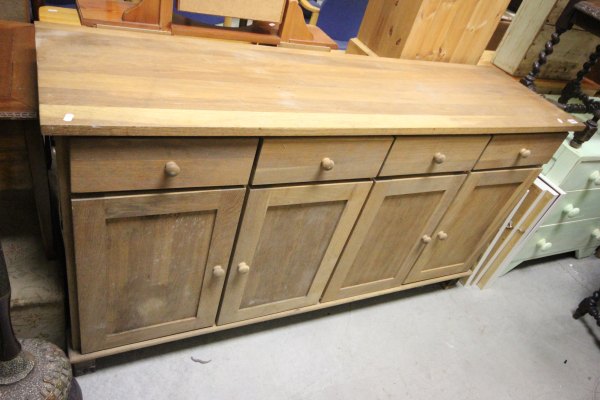 Oak dresser base with four drawers over four cupboards