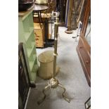 Heavy early 20th Century brass standard lamp raised on three scroll legs