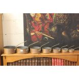 Set of Seven Graduating Copper Saucepans with Brass Handles