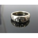 Contemporary 18ct White Gold Ring inset with Nine Diamonds of Varying Sizes