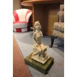 Small re-constituted stone garden statue of a naked seated lady