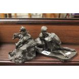 Bronzed figure of a boy and dog plus another similar of a group of Terriers