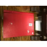 Red stamp album with a quantity of world stamps with some mint & used hinged