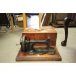 A cased vintage Frister and Rossmann sewing machine