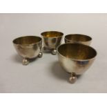 Set of Four Elkington Plate Egg Cups, each on four ball feet with Gilt Lining