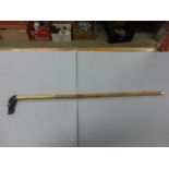 Bamboo shafted walking stick with black dogs head knop