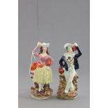 Pair of Staffordshire Figures of a Couple carrying Barrels and Bottle