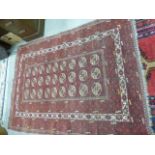 Middle Eastern red ground rug with geometric design