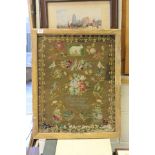 Victorian Framed Woolwork Sampler with flowers, birds and animals in a patterned border, dated 1875