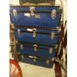 Four Large Blue Travelling Trunks