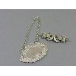 Silver Decanter Label and a Silver Double Horseshoe Brooch