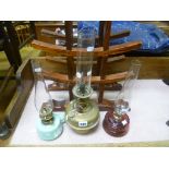 Three Victorian Oil Lamps, two with glass wells and one with brass well