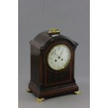 Edwardian Mahogany Inlaid Bracket Clock with brass handle to domed top and raised on four brass