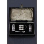 Cased Silver Cruet Set, each piece with Greek key pierced bodies and blue glass liners, Birmingham