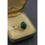 Dress Ring marked 18k set with Cabouchon Emerald and flanked by Two Diamonds