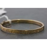 9ct Gold Hinged Bangle, half with foliate pattern engraving