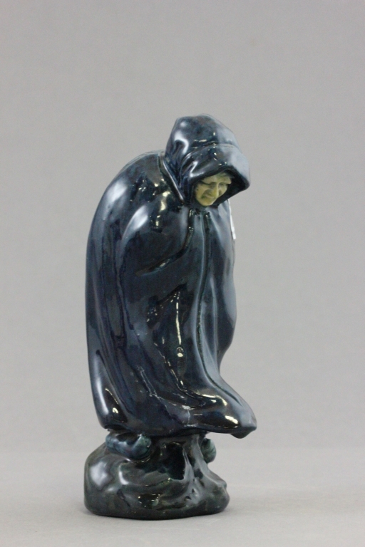 An early 20th C Art pottery figure of a cowled women