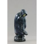 An early 20th C Art pottery figure of a cowled women