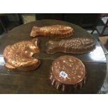 Four copper jelly moulds