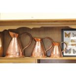 Three Graduating Copper Jugs