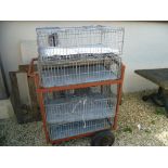 Four Chicken Cages on a Metal Trolley