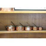 Set of five small copper graduating pans