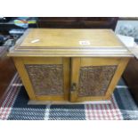 Early 20th century Oak Smokers Cabinet with Carved Panel Doors