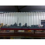 Well built plastic model battle ship within large case on wooden plinth 46" in length