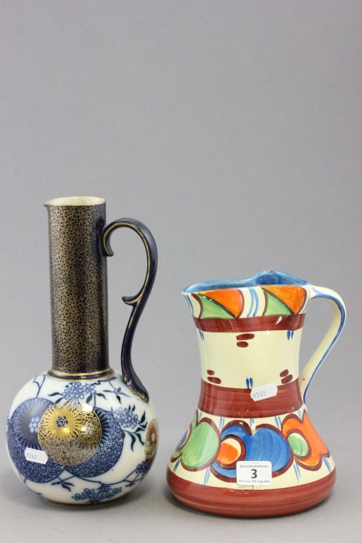 A Doulton Burslem pottery jug with elongated neck and scroll handle; decorated in the Arts and