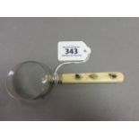 A silver plated hand held magnifying glass with shibiyama handle