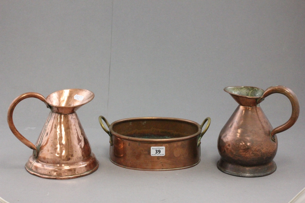 Two antique copper jugs and a similar pot