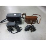 A cased pair of Hetel and Reuss binoculars together with another pair of binoculars and a