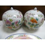 A pair of Chinese porcelain famille rose ginger jars and covers