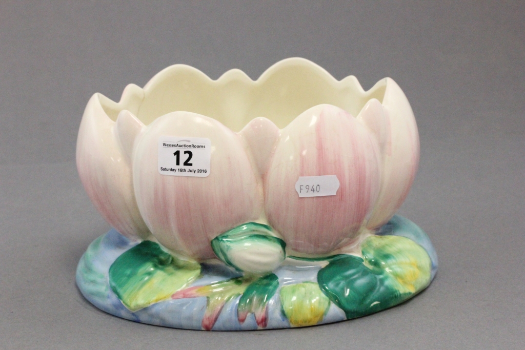 A Clarice Cliff water lily bowl; the pink coloured lilly raised on blue and green painted base;