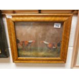 A maple framed oil painting of fighting cocks in a landscape