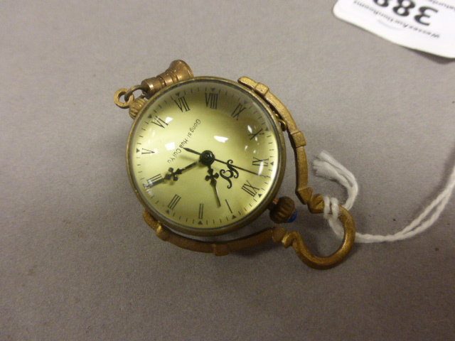 A brass and glass fob watch