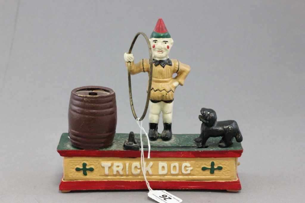 A 20th century painted cast iron novelty money box; in the form of a clown and a dog doing a