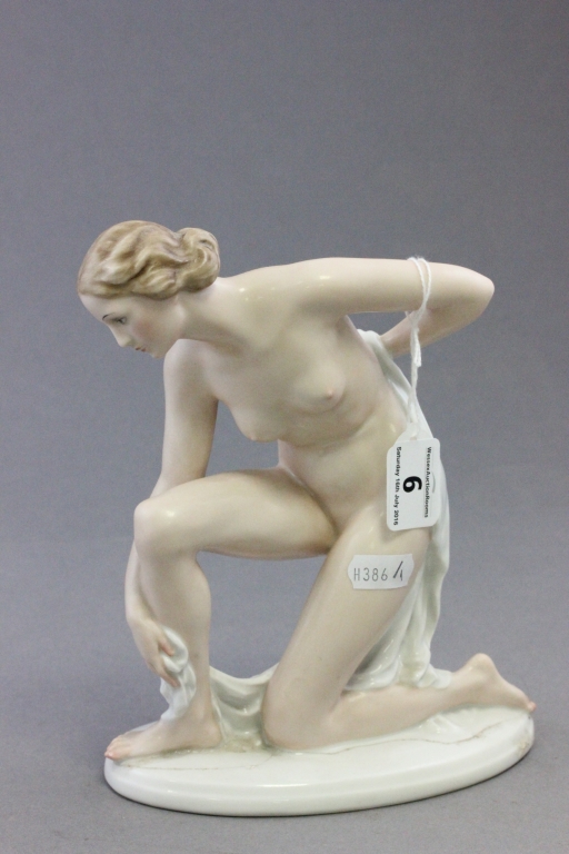 A Rosenthal porcelain model of a naked kneeling lady, bearing impressed 783 to base (a/f)