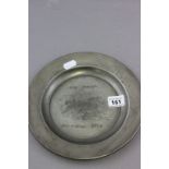 An early circular pewter plate; decorated with naively engraved with a fox hunting scene entitled