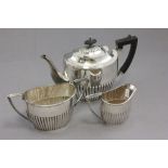 A three piece Walker & Hall silver plated tea set comprising; teapot with wooden handle, two handled