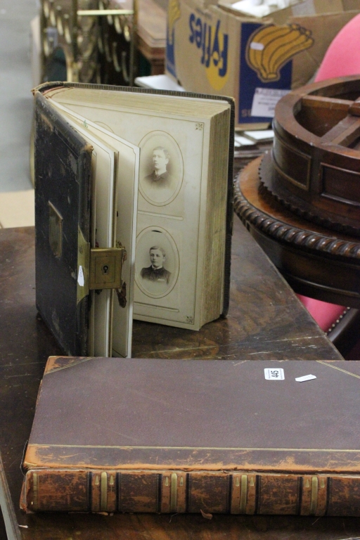 A Victorian leather bound photograph album together with various photographs with brass mounts