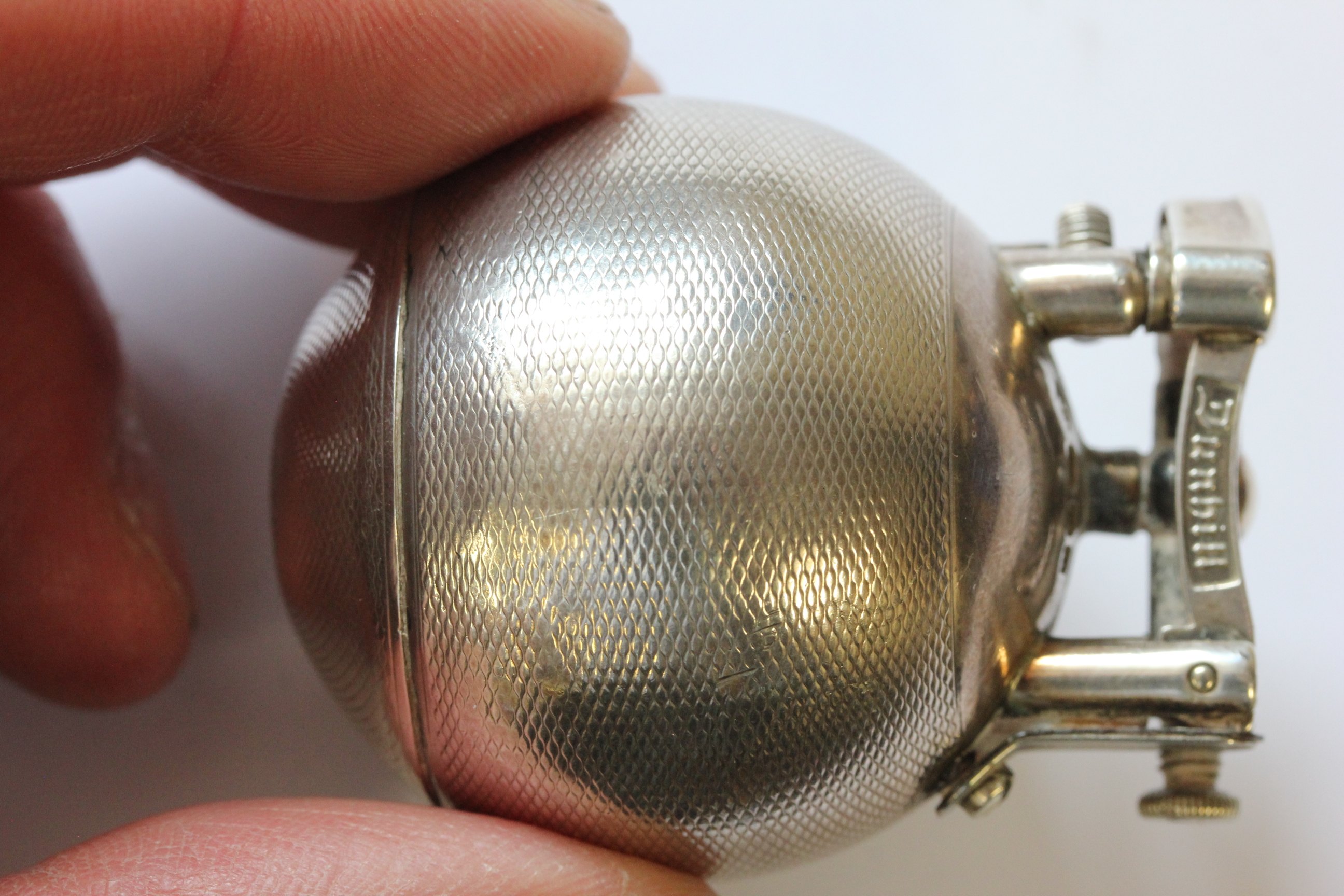 A hallmarked silver Dunhill lighter; of spherical form; with engine turned decoration; the hinged - Image 12 of 14