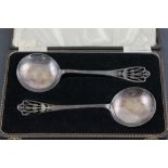 A cased pair of George V hallmarked silver spoons, with pierced handles; Lanson Limted; Birmingham