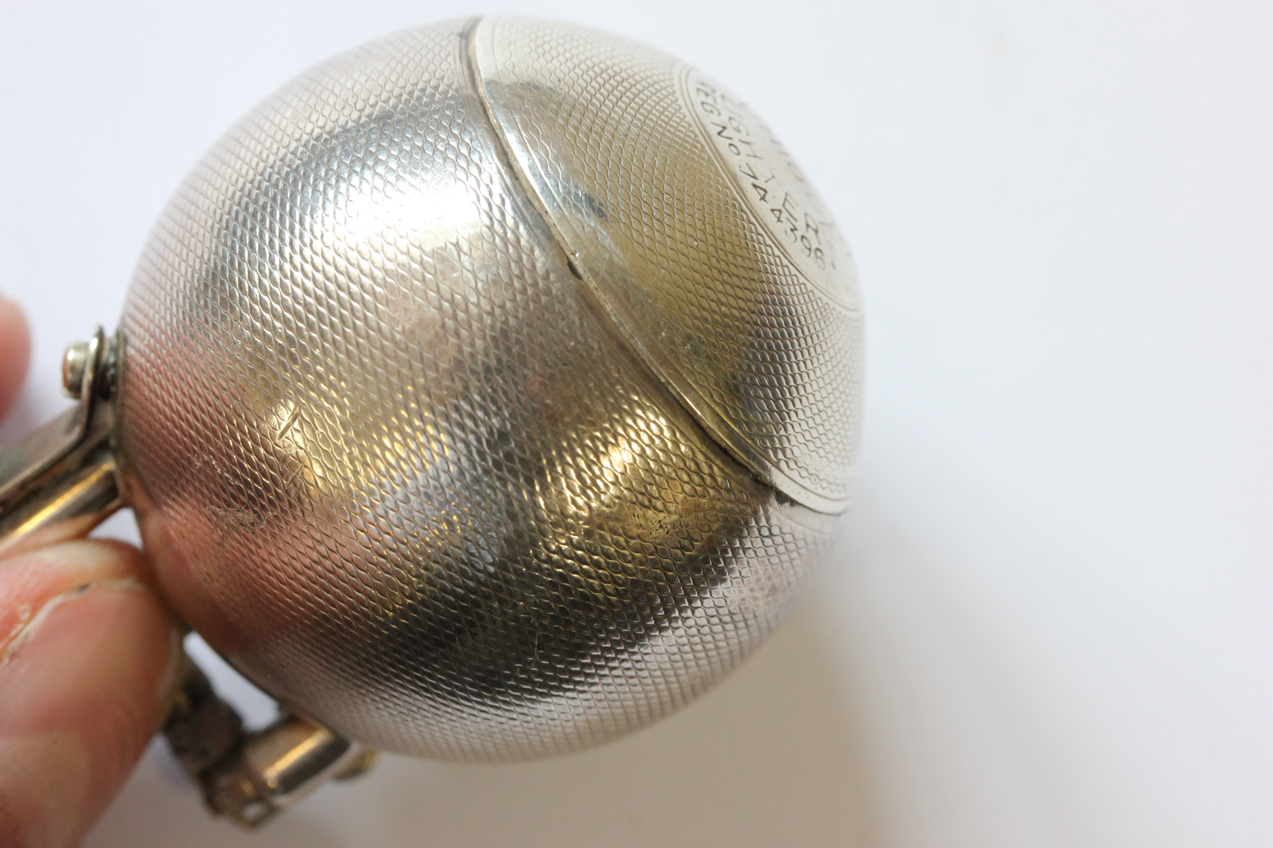 A hallmarked silver Dunhill lighter; of spherical form; with engine turned decoration; the hinged - Image 9 of 14