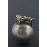 A hallmarked silver Dunhill lighter; of spherical form; with engine turned decoration; the hinged