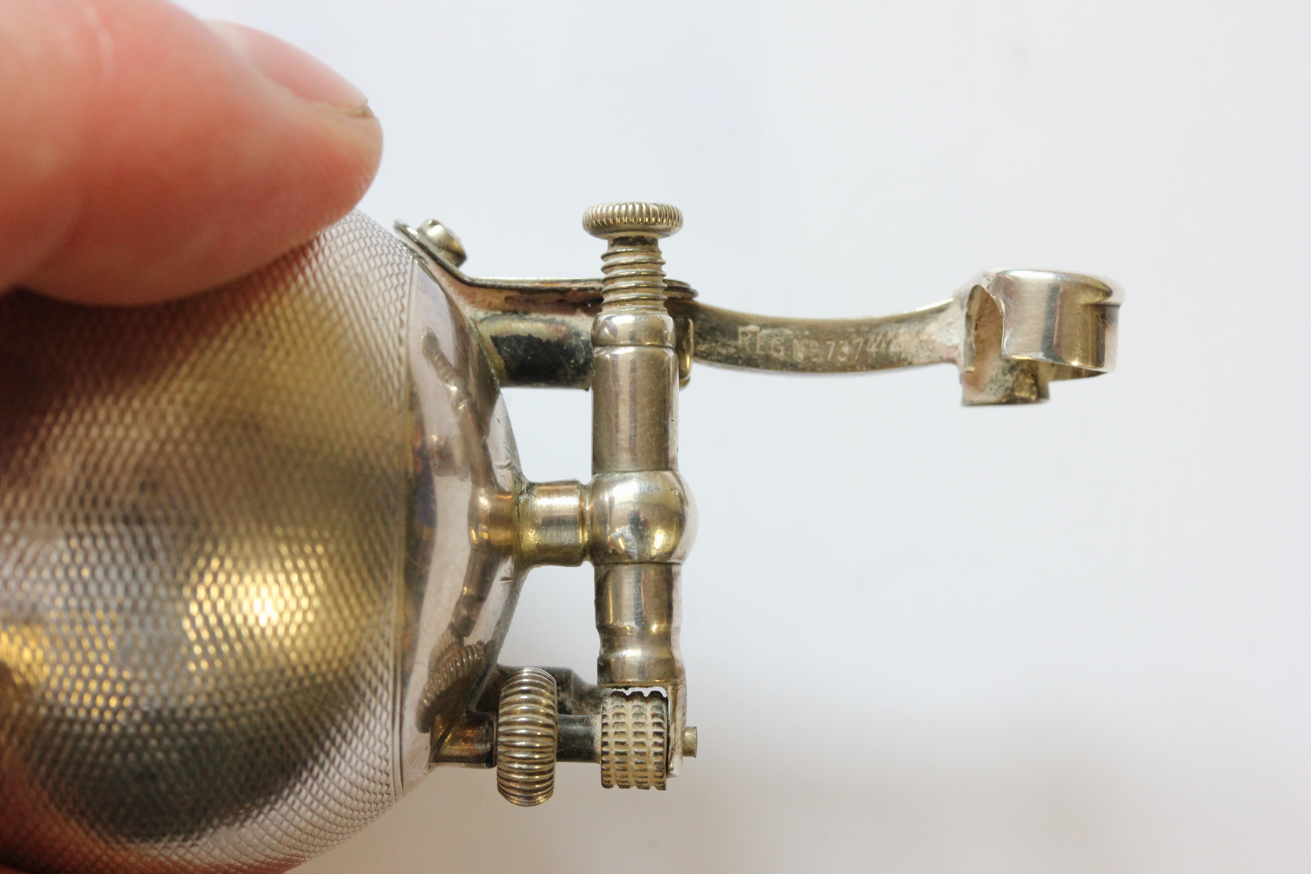 A hallmarked silver Dunhill lighter; of spherical form; with engine turned decoration; the hinged - Image 6 of 14