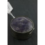 A hallmarked silver circular pill box and cover; set with amethyst; makers mark worn; Birmingham