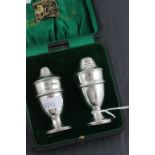 A cased George V hallmarked silver salt and pepper set; with banded decoration; Barker Brother;
