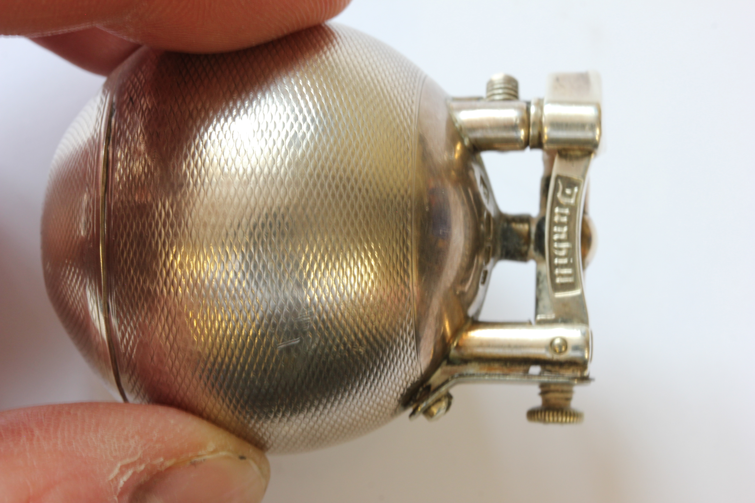 A hallmarked silver Dunhill lighter; of spherical form; with engine turned decoration; the hinged - Image 2 of 14